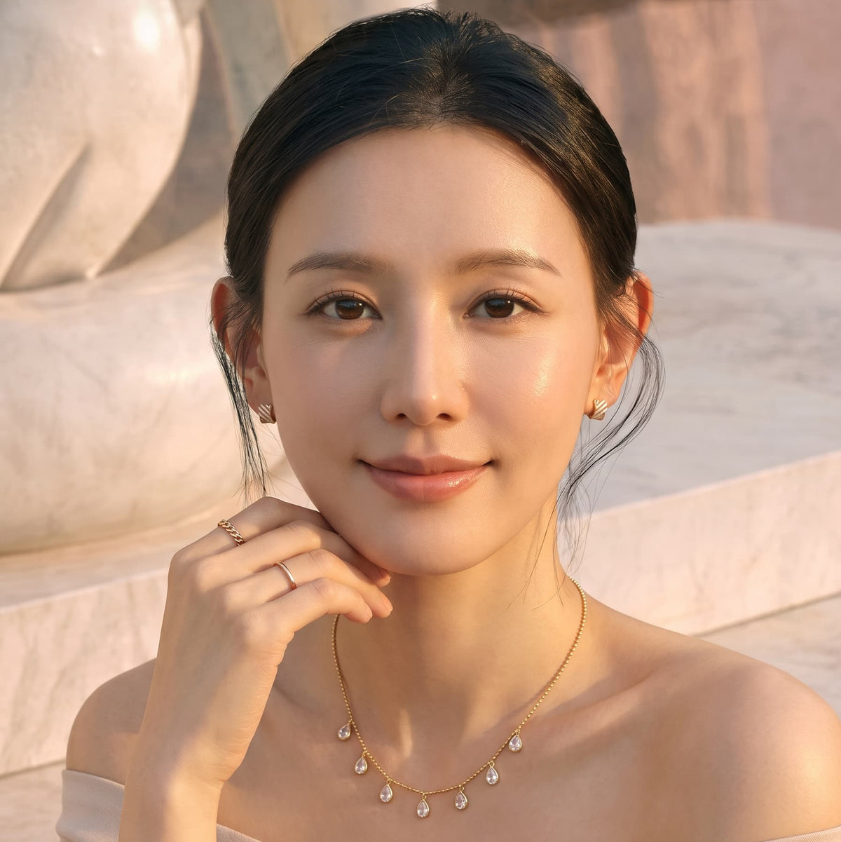 Front view of a woman smiling, wearing the gold Aria Teardrop Station Necklace by GinakimKR. Delicate 42cm gold beaded chain with dangling Czech glass drops.