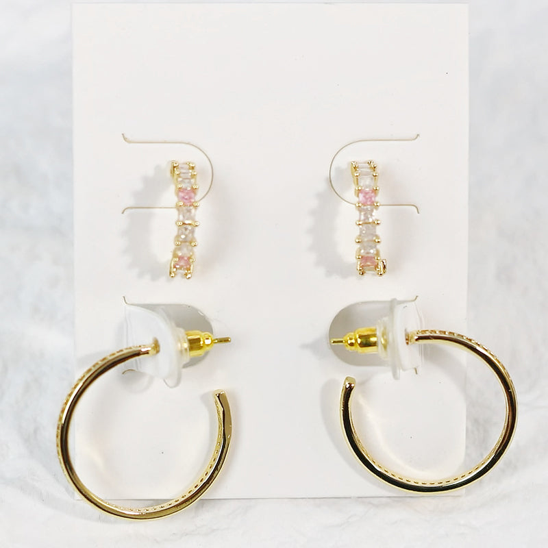 Full front shot of Blush Beam Earring Set, with geometric hoops and pearl-accented studs laid on neutral background.