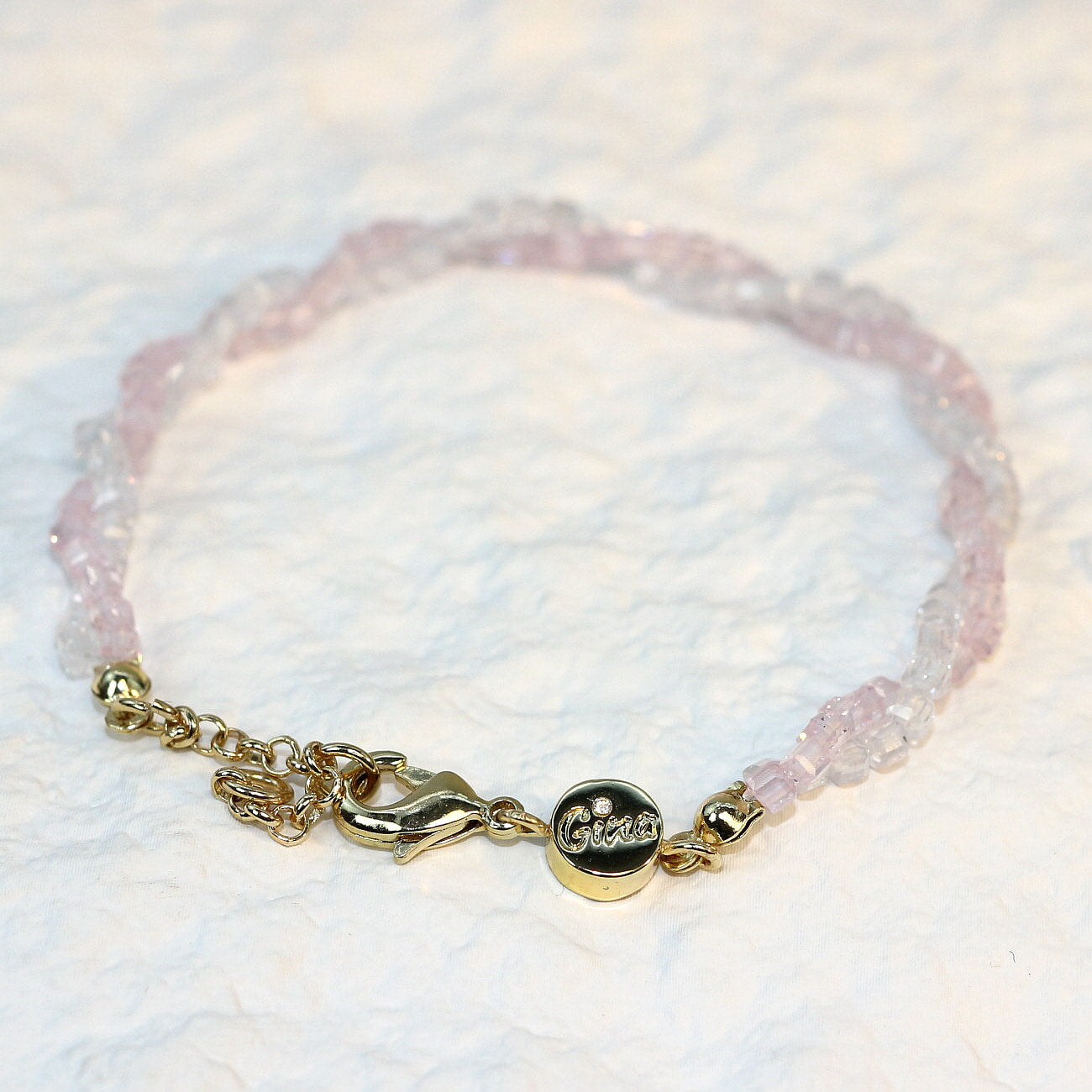 A close-up of the Blush Prism Bracelet, showcasing warm champagne-pink crystal beads with a luminous finish. The stretch bracelet features a sparkling CZ accent bead, styled on a woman’s wrist with soft natural lighting for an elegant, feminine look.