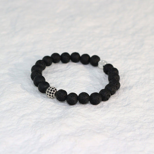 Flat-lay view of the Lava Strength Bracelet highlighting the porous texture of natural lava stones, crafted for a minimalist unisex style.