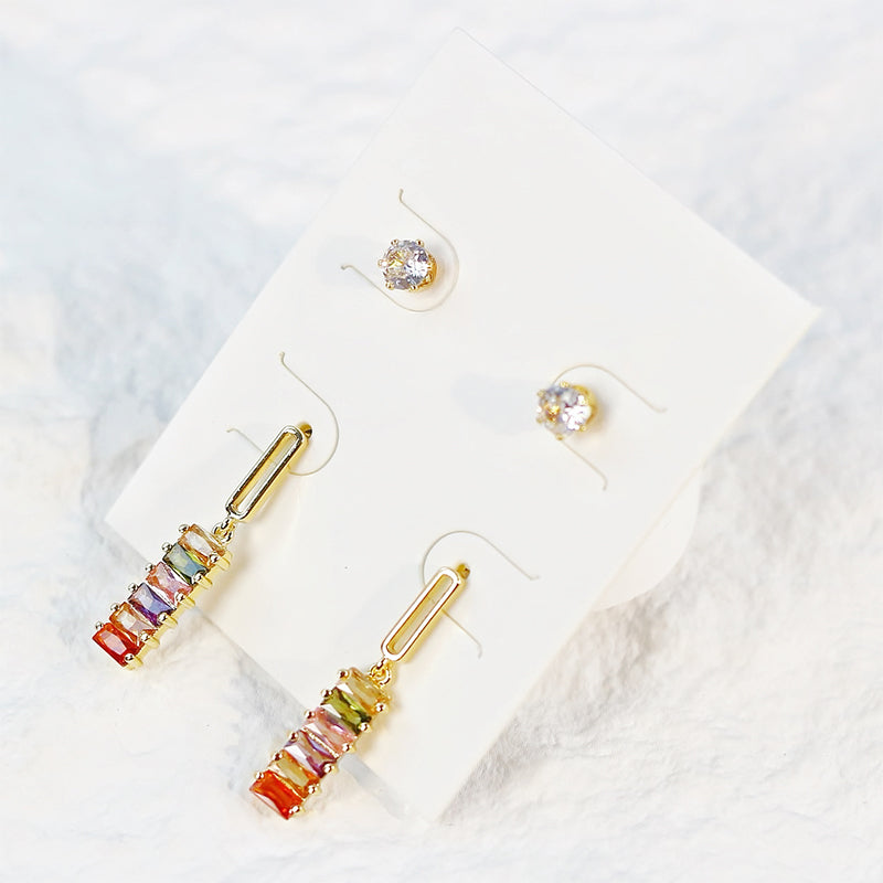 Flat lay of GinaKimKR Lightfall Duo Earring Set showcasing subtle color variations in bead details and gold-tone bars.