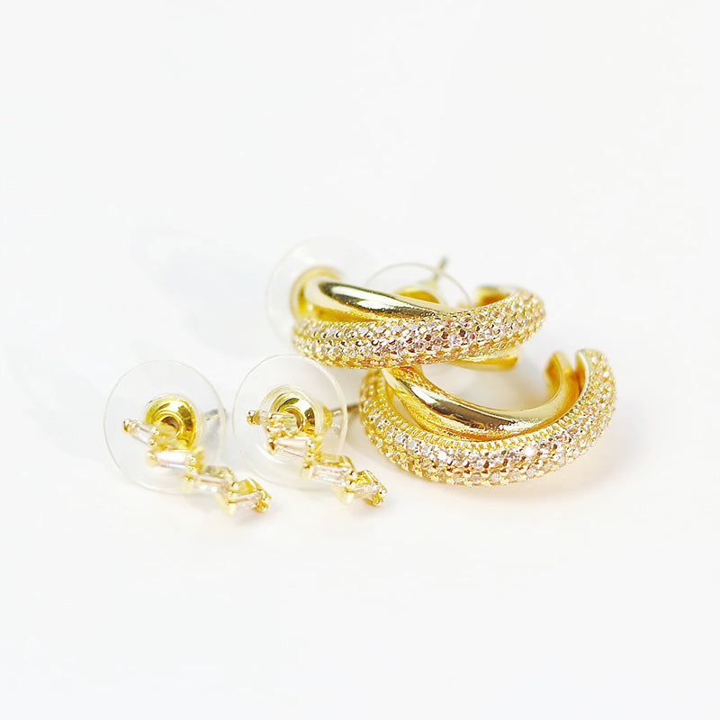 Close-up of Luna Curve Earring Set showing three pairs of gold-toned hoops and studs with smooth curved finishes.