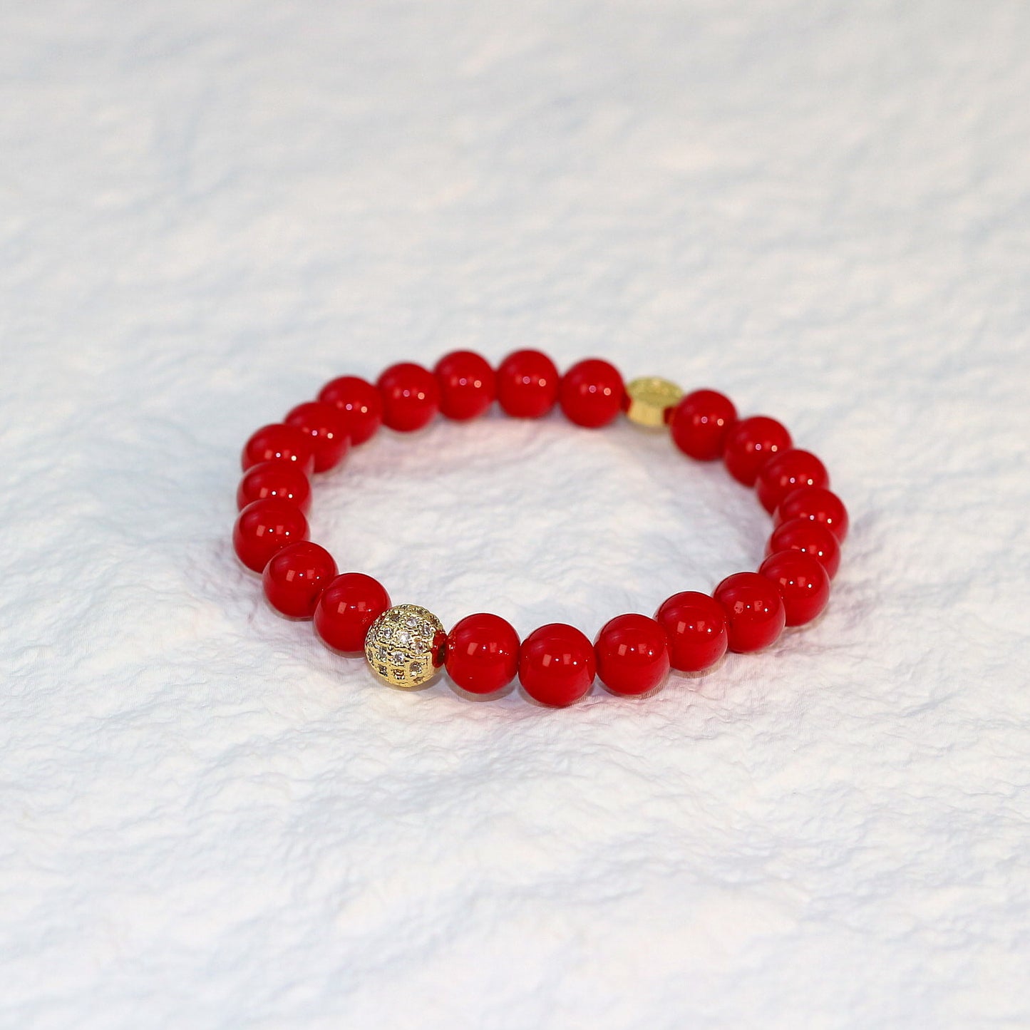 Angled product view of the Red Jasper Strength Bracelet, emphasizing the deep earthy red color and natural variations of each jasper bead.