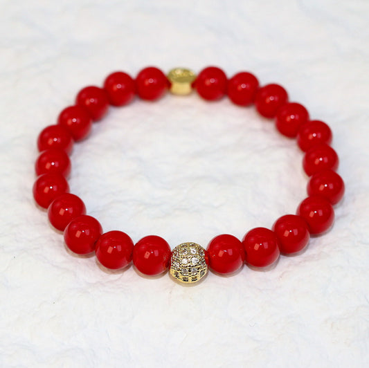 Top-down view of the Red Jasper Strength Bracelet with evenly spaced red natural stone beads and a subtle sheen, symbolizing vitality and balance.