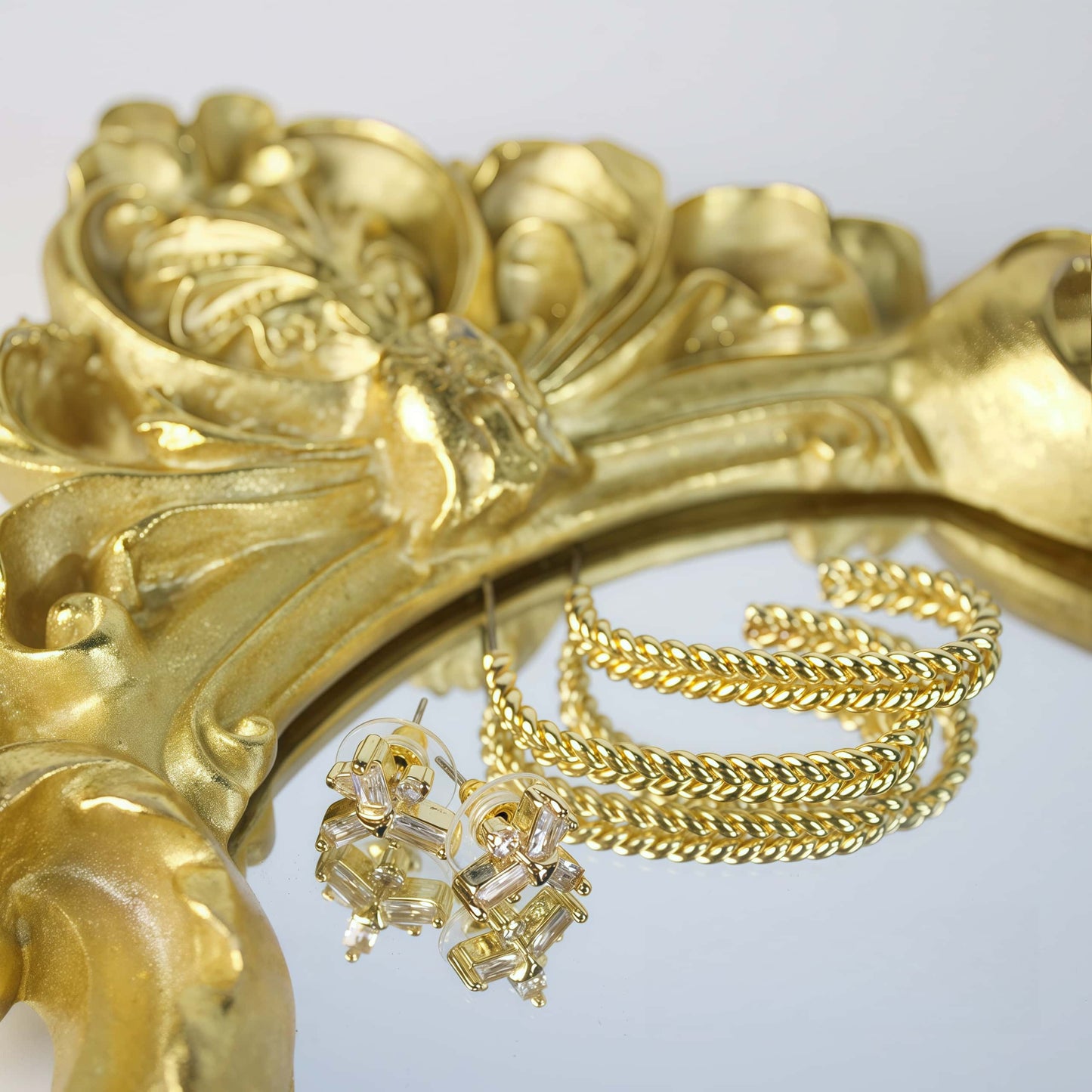 Twisted gold hoop earrings and CZ floral studs reflected on ornate mirror – Twist Bloom Earring Set by GinaKimKR