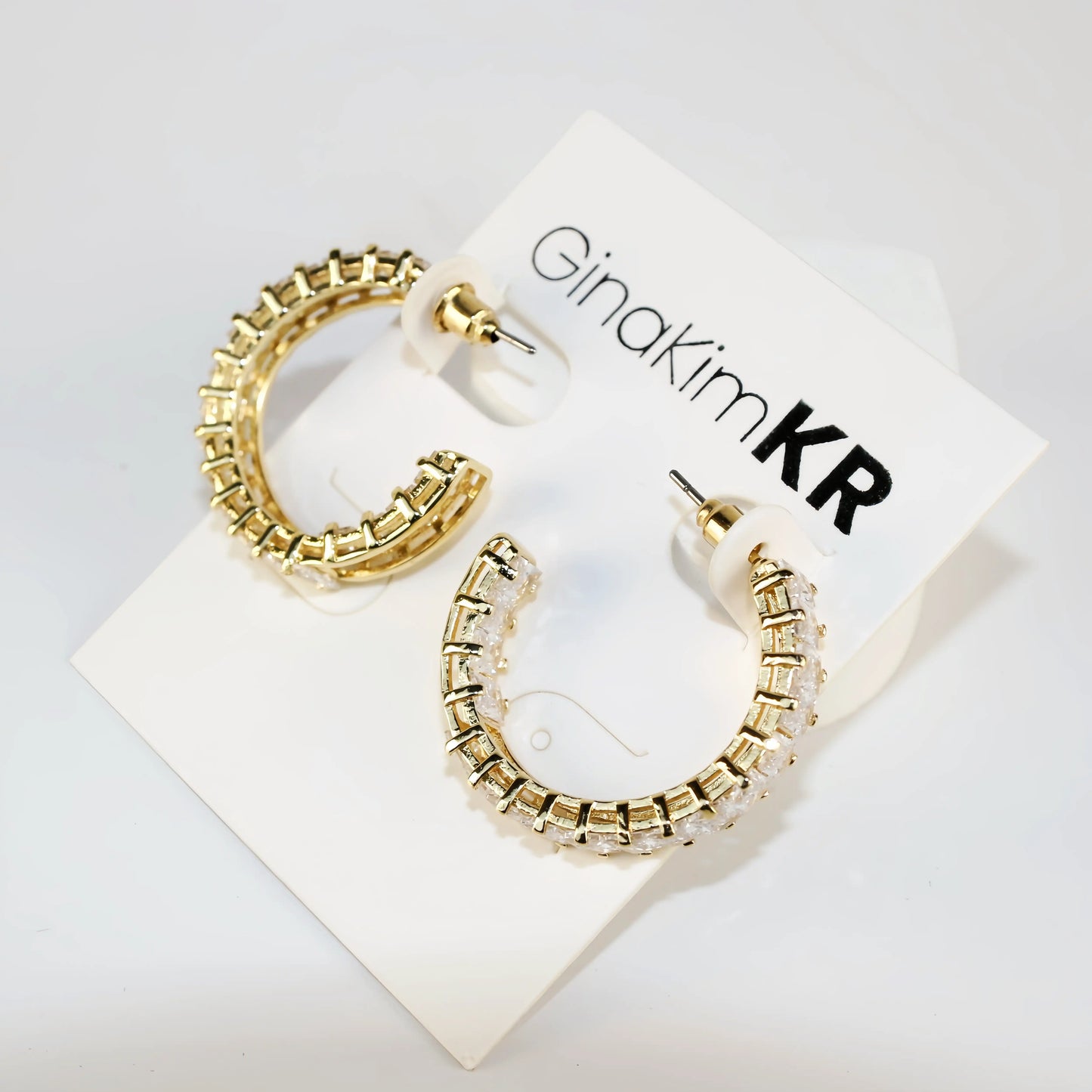 Celeste Crown Earrings shown at a side angle highlighting 28mm gold hoop thickness.