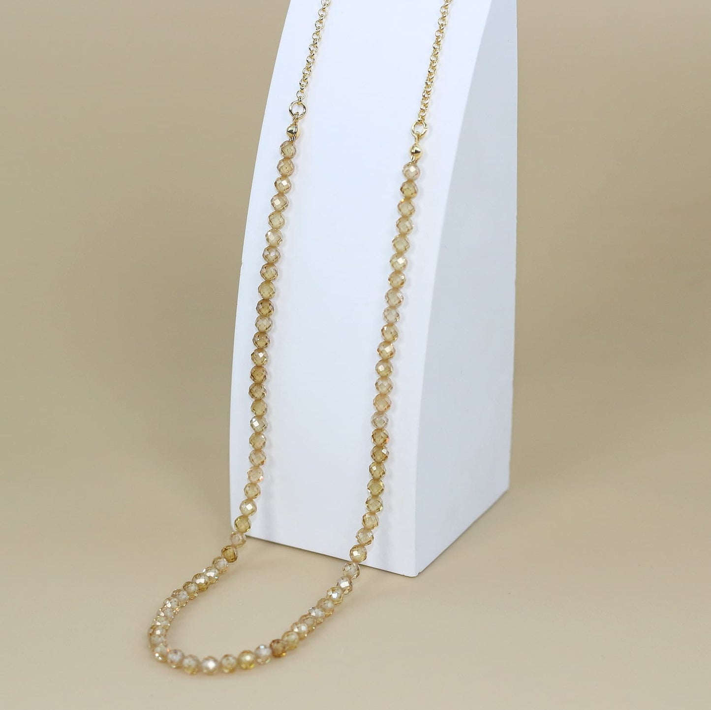 Champagne Light Necklace with faceted cubic zirconia beads and a gold-plated extender chain, styled for refined Korean elegance.
