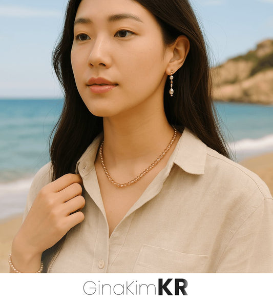 A woman wearing the Champagne Light Necklace by GinaKimKR, with subtle sparkle from champagne-toned faceted beads resting softly along her neckline.