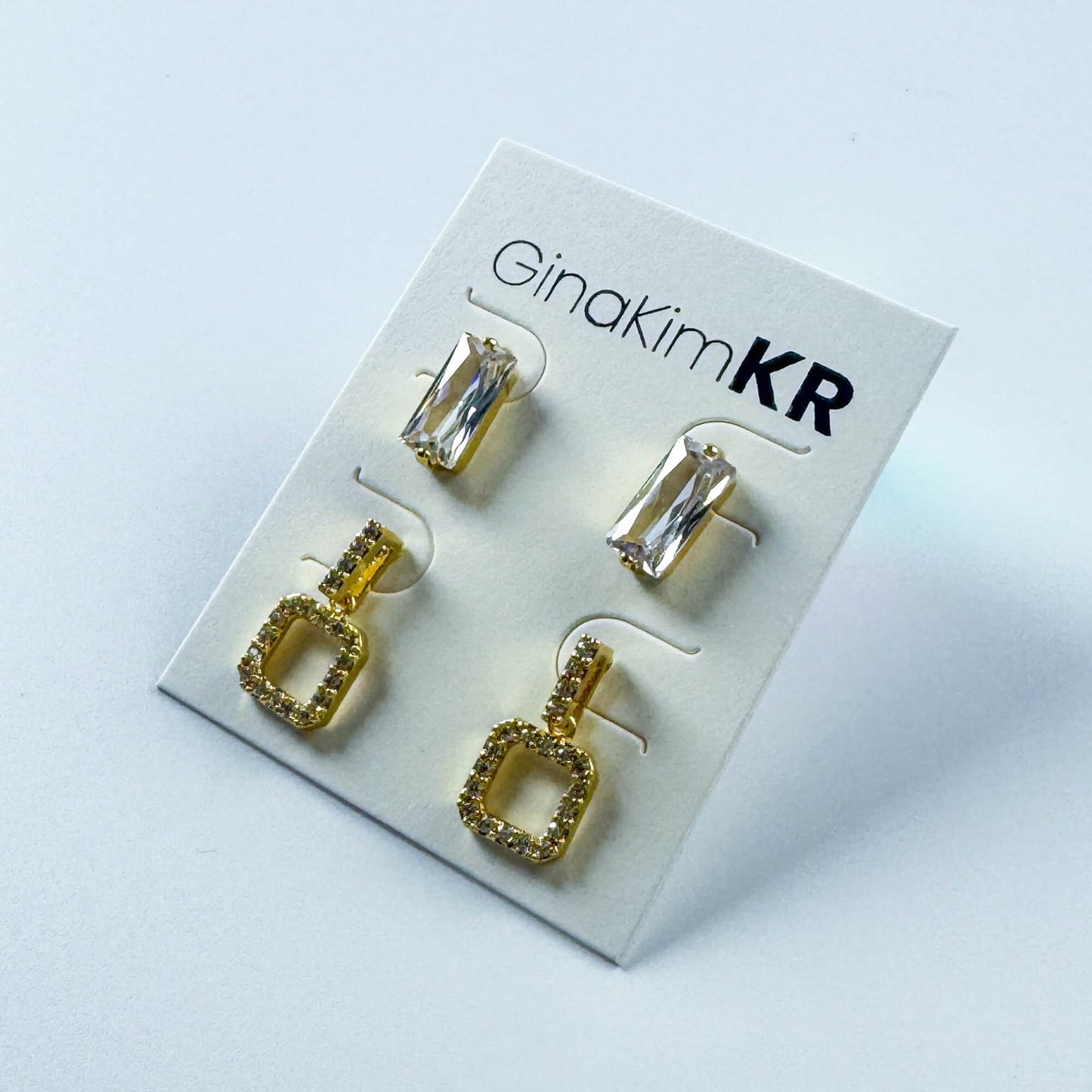 Crystal Edge Duo Earring Set by GinaKimKR featuring CZ drop earrings and rectangular studs, displayed at an angled front view