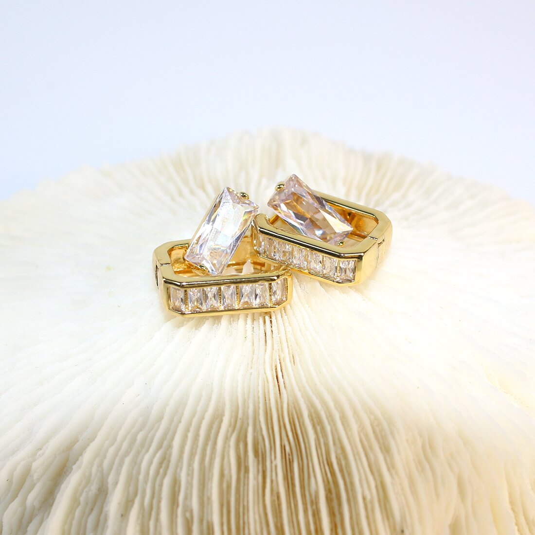 Close-up of gold huggie hoop earrings with 7 baguette CZs from Crystal Line Duo set