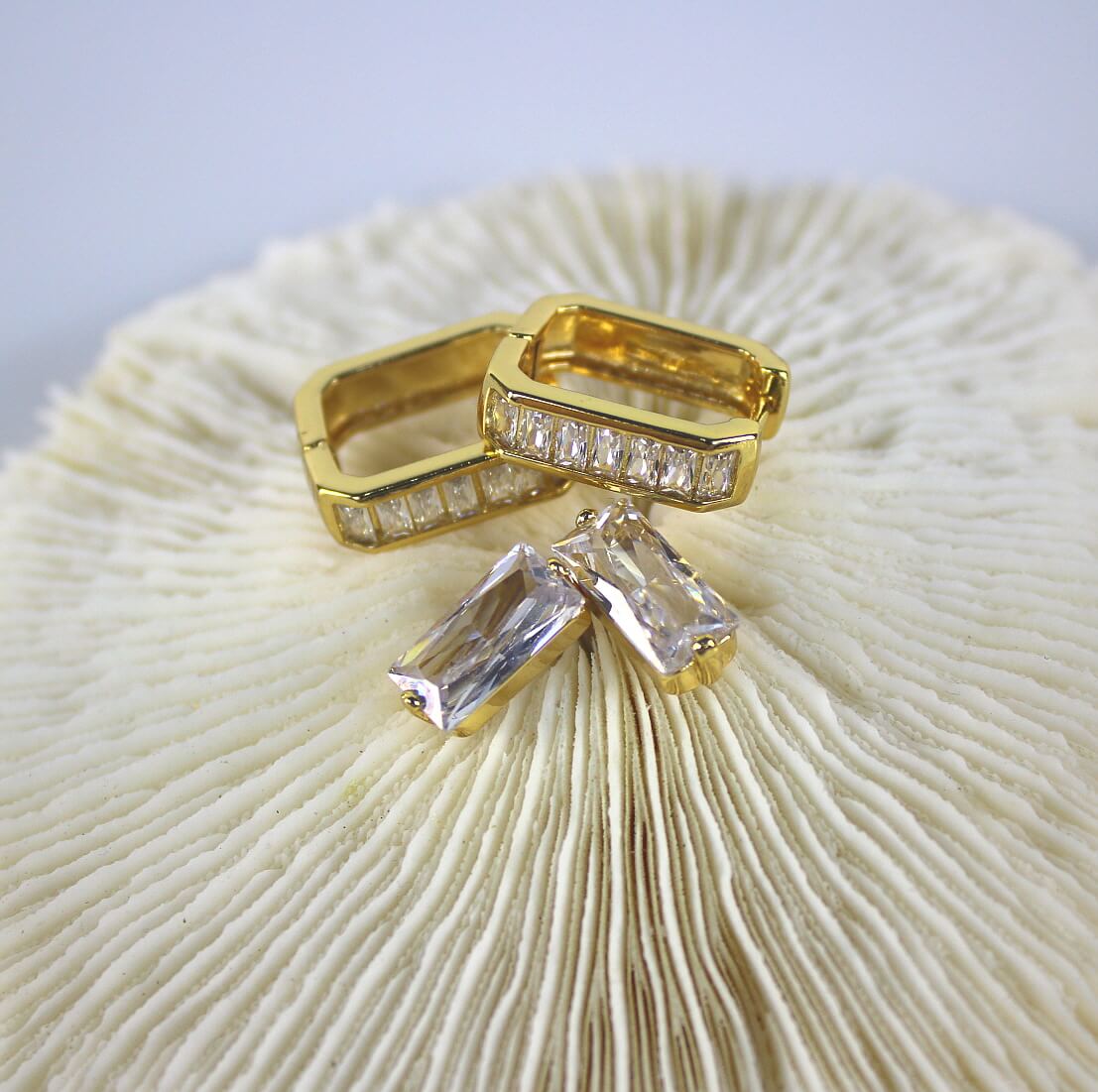 Overhead view of Crystal Line Duo by GinaKimKR – showcasing crystal-lined hoop and CZ post earrings