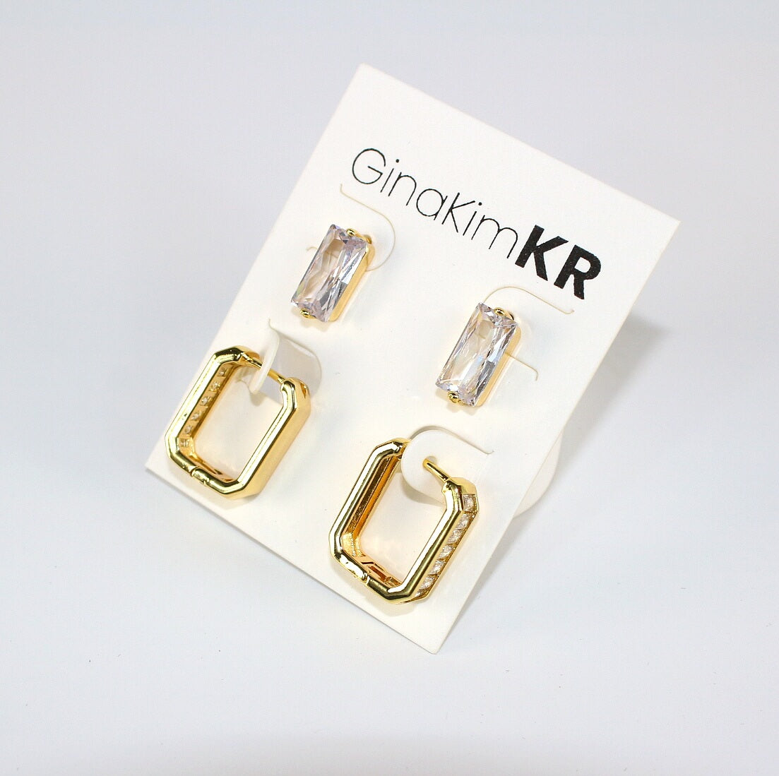 Crystal Line Duo by GinaKimKR – CZ post studs and baguette-cut crystal hoop earrings displayed on branded earring card