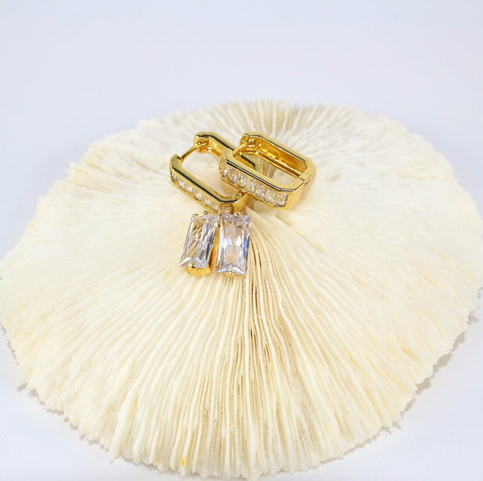 Top view of Crystal Line Duo earrings styled on soft white background – baguette hoops and CZ studs