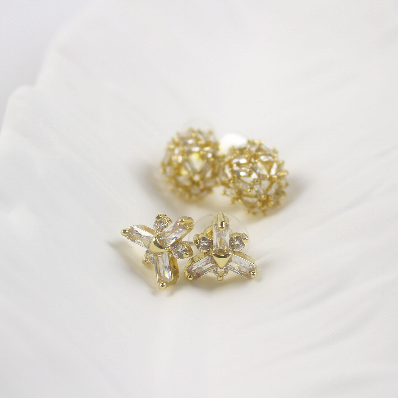 Frostlight duo earrings highlighting snowflake CZ studs with dome studs in background, GinaKimKR jewelry