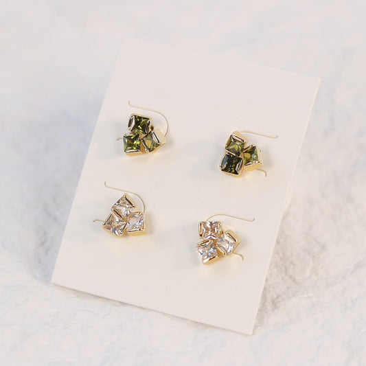 Top view of Geo Trio Earring Set with triangle-shaped CZ studs in clear and olive tones, on white card.