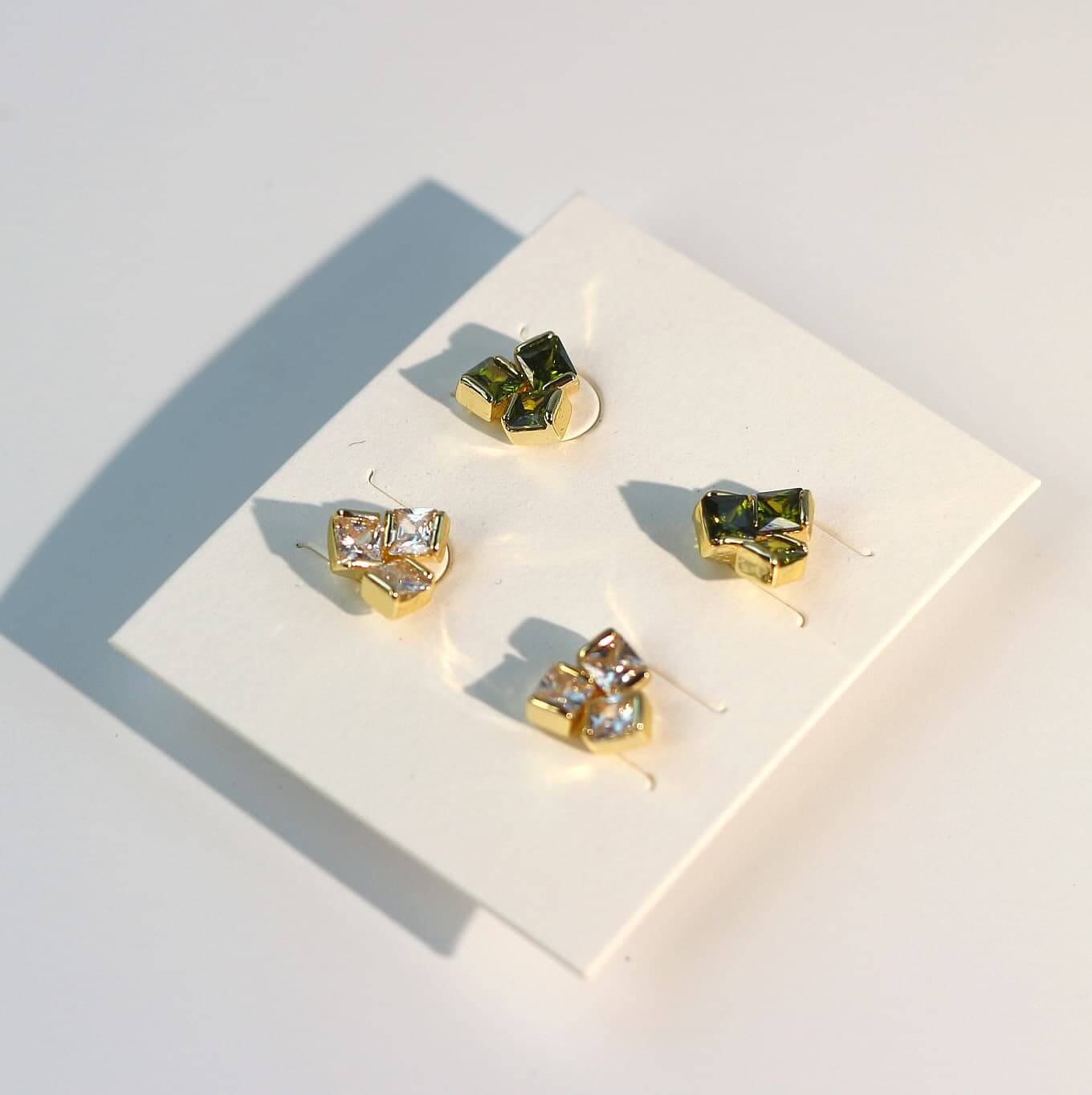 Side-angled photo of triangle-shaped CZ earrings from Geo Trio Set, highlighting post and stud design.