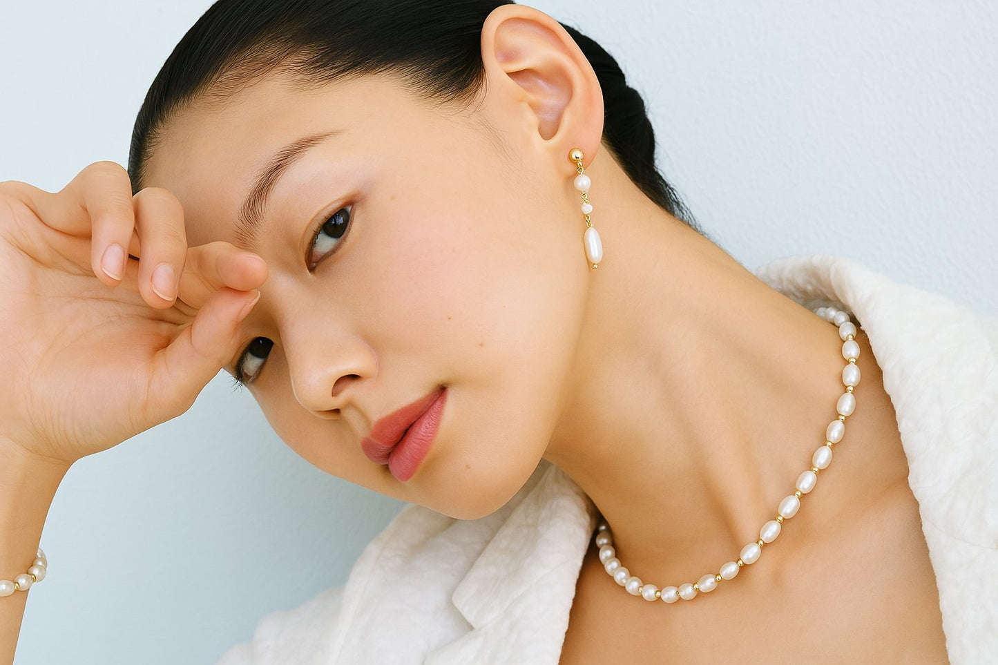 Model wearing Gina Kim Pearl Whisper Bracelet and Serenity Pearl Necklace, styled with a soft neutral look