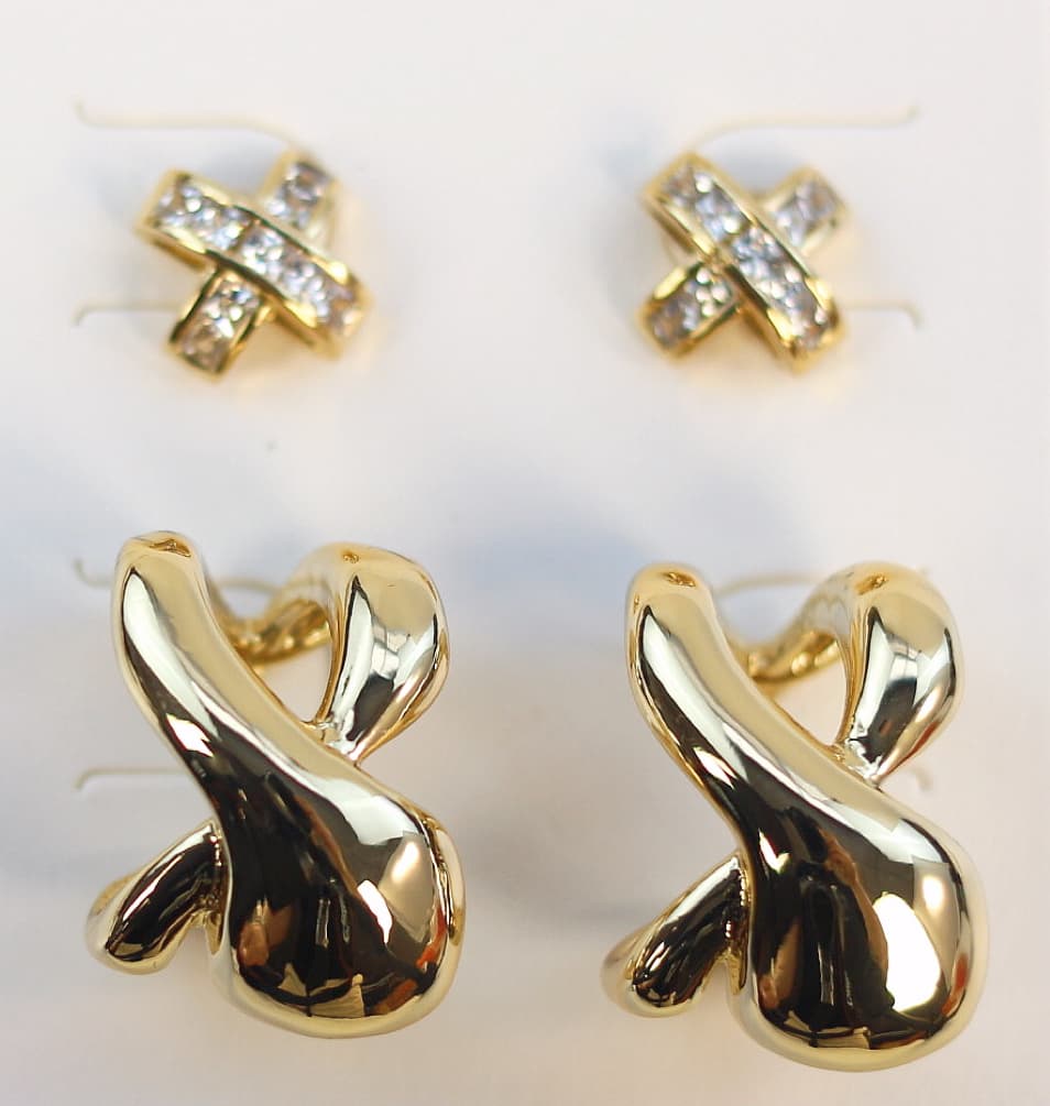 Angled view of Eternal Flow Earring Set showing bold curved earrings and shimmering CZ-encrusted crisscross studs on a clean white card.