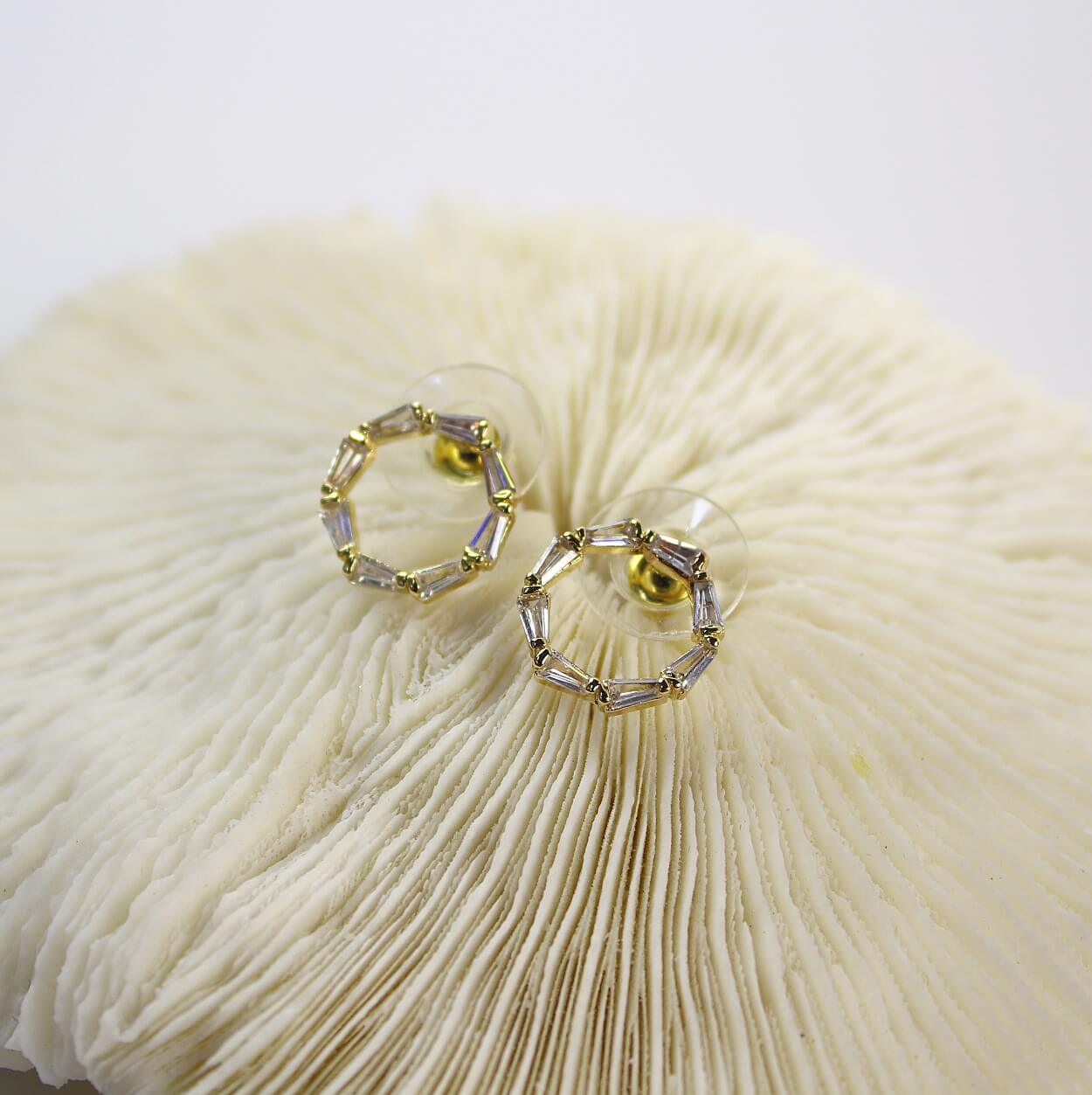 Close-up of 14K gold plated hoop earrings from GinaKimKR Golden Circle Duo set, textured reflective finish