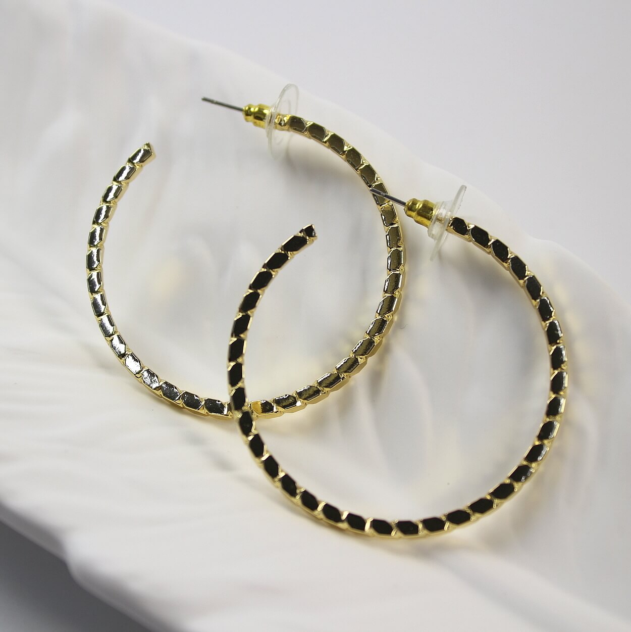 C-shaped gold hoop earrings from GinaKimKR Golden Circle Duo Earring Set, reflective geometric texture
