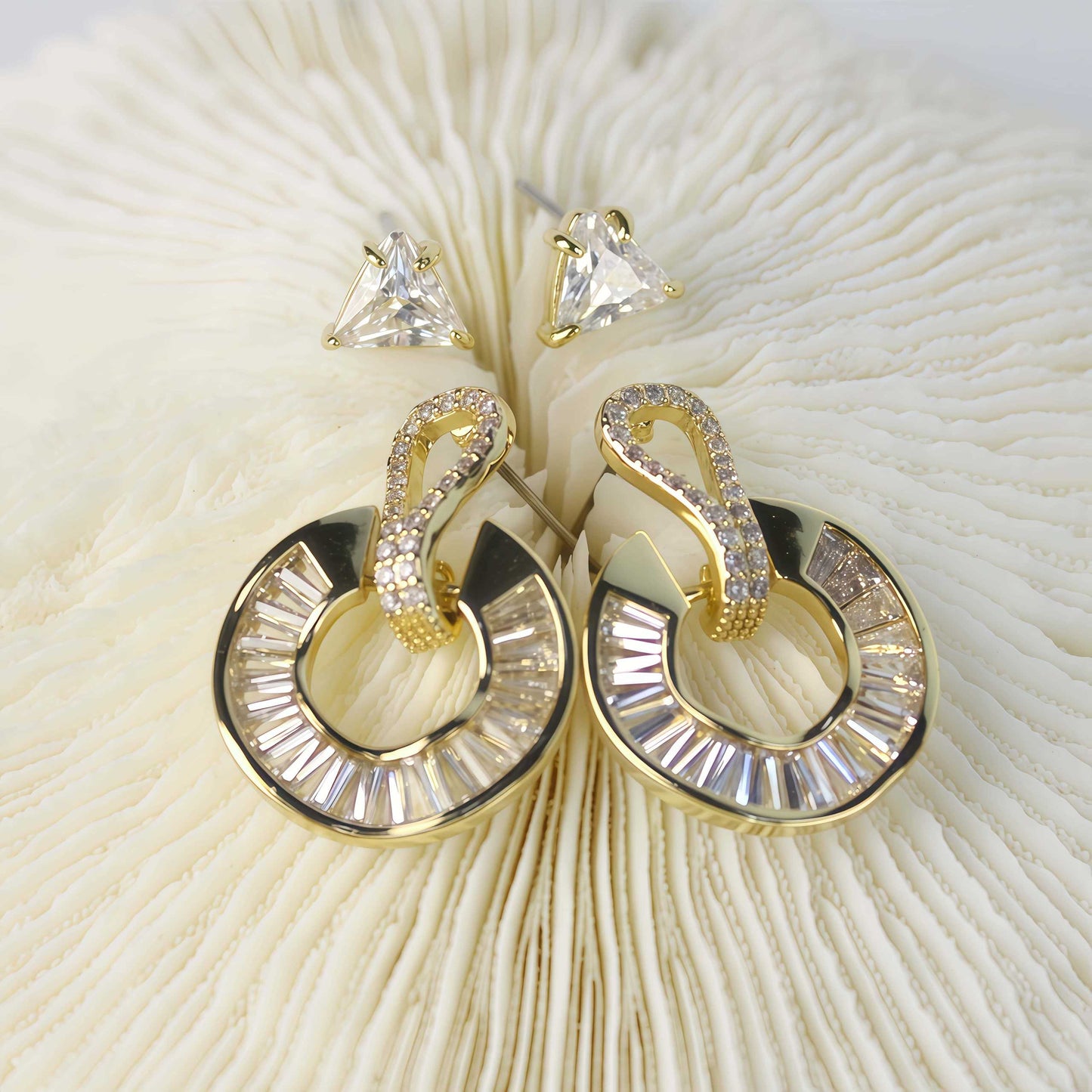 Gold loop drop earrings with baguette-cut crystals from the Golden Edge Duo set, displayed on soft cream fur background