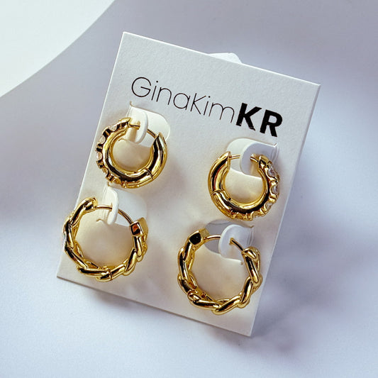 Set of four gold huggie earrings in polished and braided textures, displayed on a GinaKimKR card under soft daylight.