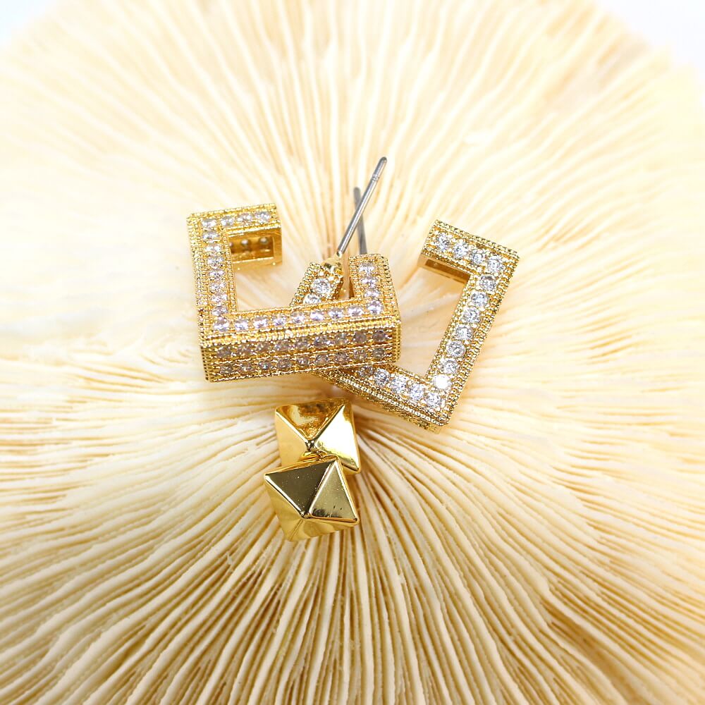 Pyramid post earring close-up from Golden Structure Set – bold gold tone with mirror shine