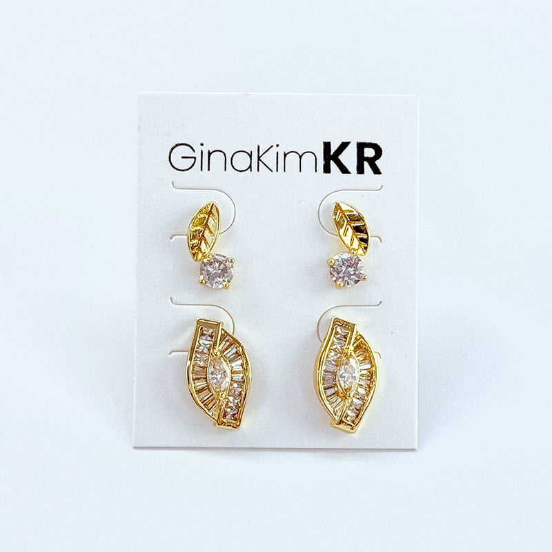 GinaKimKR's Harmony Leaf Trio Earring Set shown on display card, featuring gold leaf design with CZ stones.