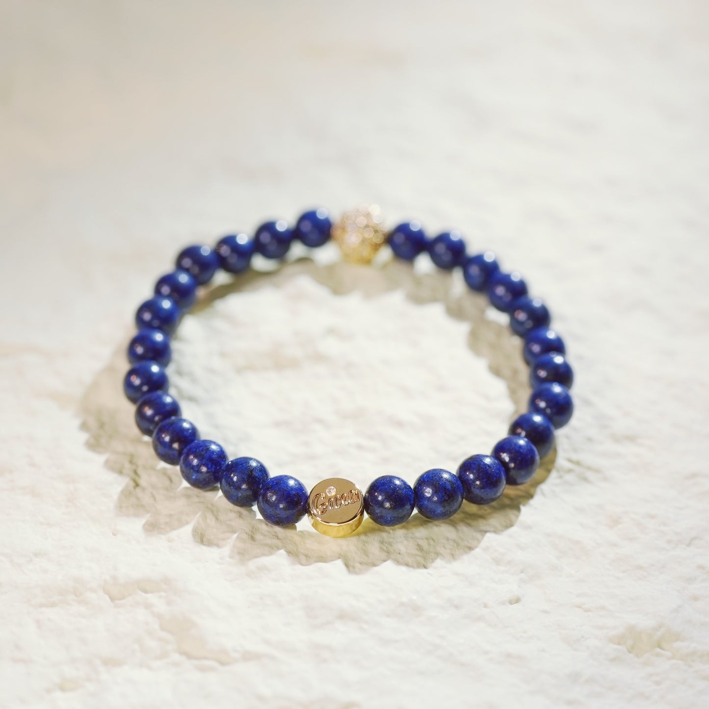 Handcrafted bracelet with lapis lazuli beads and silver CZ centerpiece. Made by GinaKimKR to balance strength and elegance in everyday wear.
