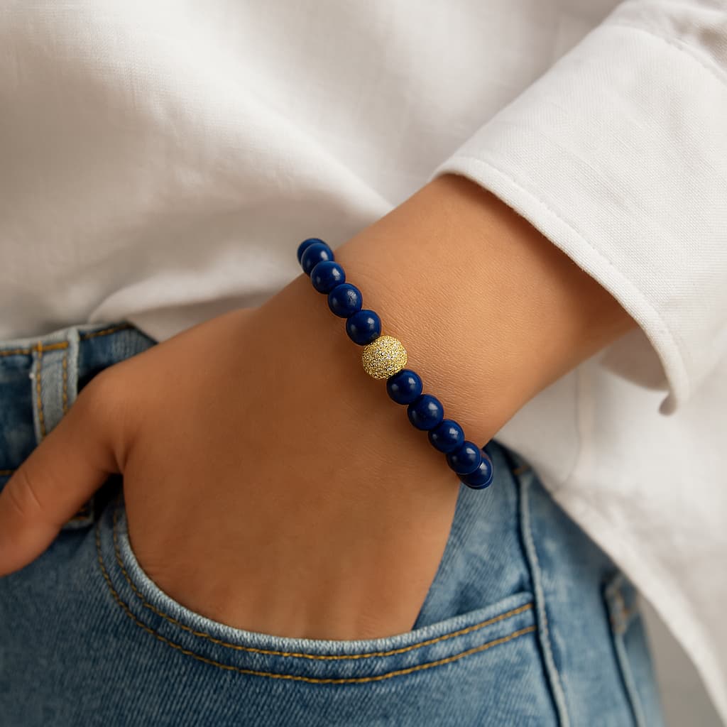 A person wearing the Lapis Lazuli Fortune Bracelet by GinaKimKR. The blue stones and silver accents stand out in a refined, modern look.