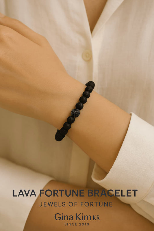 A person wearing the Lava Fortune Bracelet by GinaKimKR, featuring matte black lava beads and silver-toned details. Strong, simple, and centered.