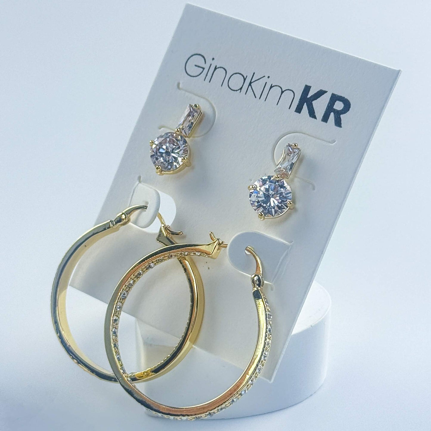 Flat lay of Luna Spark Earring Set with brand card, showing full product and jewelry styling details