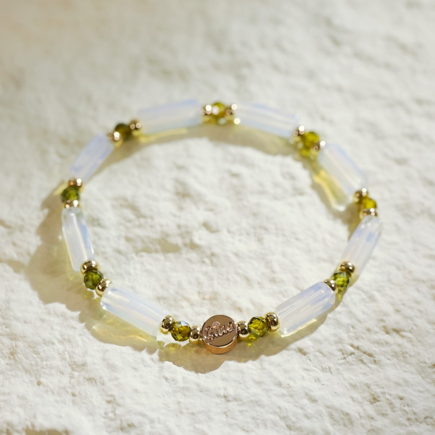 Refined moonstone bracelet with rectangular beads and green CZ centerpiece. Handmade by GinaKimKR for a sense of calm, focus, and gentle strength.