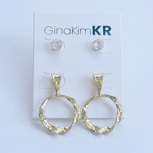Angled display of GinaKimKR Molten Circle Earring Set featuring sculpted gold hoops and cubic zirconia studs