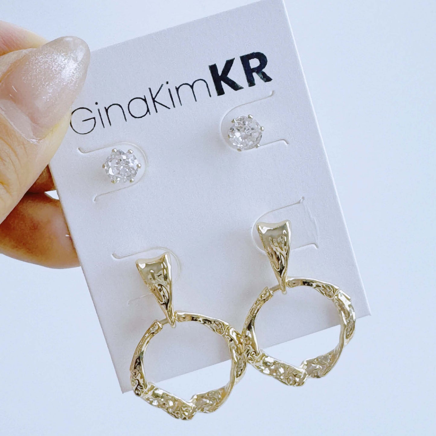 Detail shot of gold hoop texture from GinaKimKR’s Molten Circle Earring Set held in hand