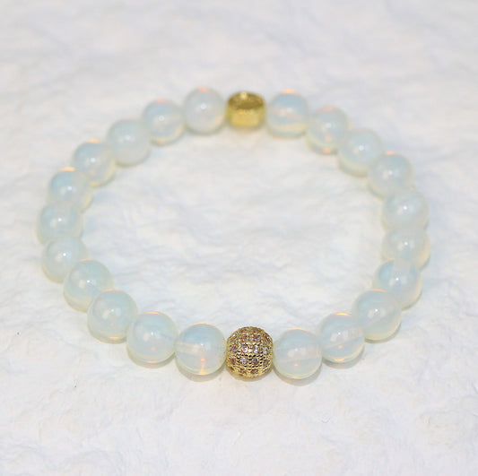 Angled image of the Moonstone Strength Bracelet showing gentle pastel glow and smooth round stones, symbolizing inner peace and clarity.