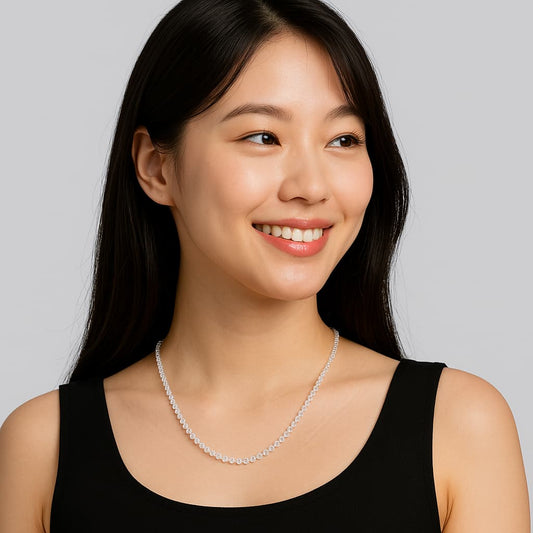 A woman wearing the Morning Light Necklace by GinaKimKR, showing soft sparkle from crystal CZ beads and gold accents. Radiant and versatile for daily elegance.