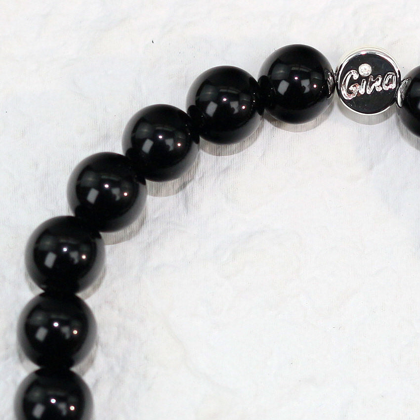Close-up side view of the Onyx Strength Bracelet revealing smooth, reflective surfaces of the beads, perfect for grounding and confidence.