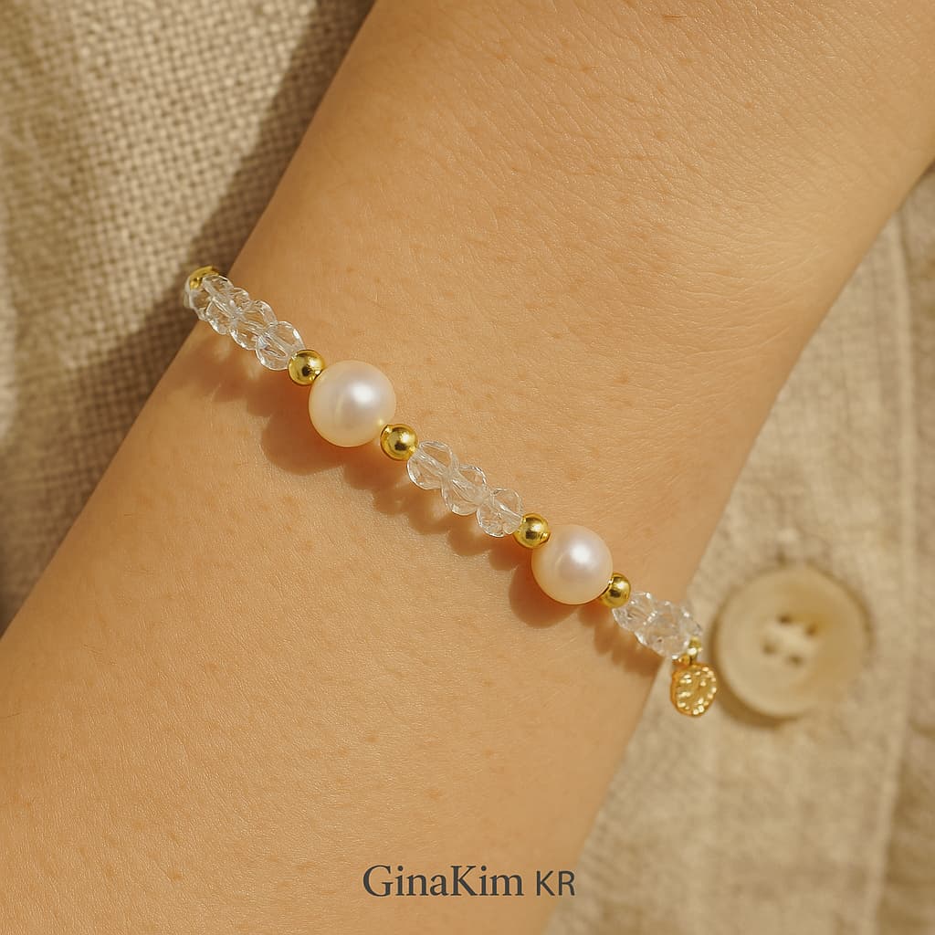 Serene close-up of a woman’s wrist wearing the Crystal Pearl Whisper Bracelet by GinaKimKR, combining natural pearls and crystal quartz for a peaceful, mindful look—ideal for gifting or daily wear.