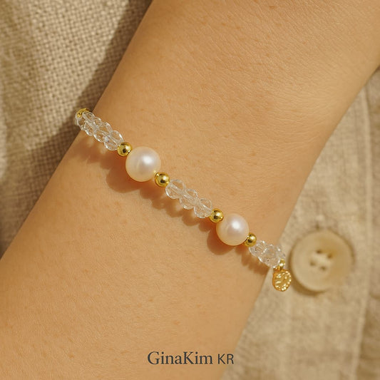 Serene close-up of a woman’s wrist wearing the Crystal Pearl Whisper Bracelet by GinaKimKR, combining natural pearls and crystal quartz for a peaceful, mindful look—ideal for gifting or daily wear.