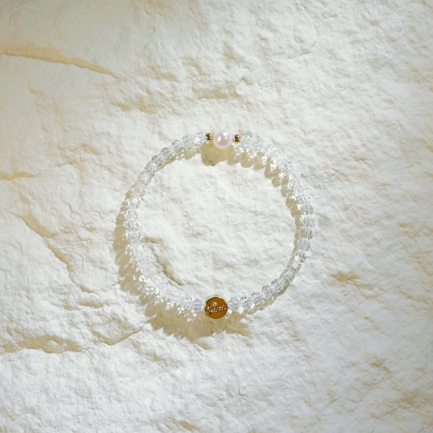 Handmade bracelet with faceted crystal quartz, one freshwater pearl, and gold-plated spacers. Designed by GinaKimKR for quiet elegance and inner clarity.
