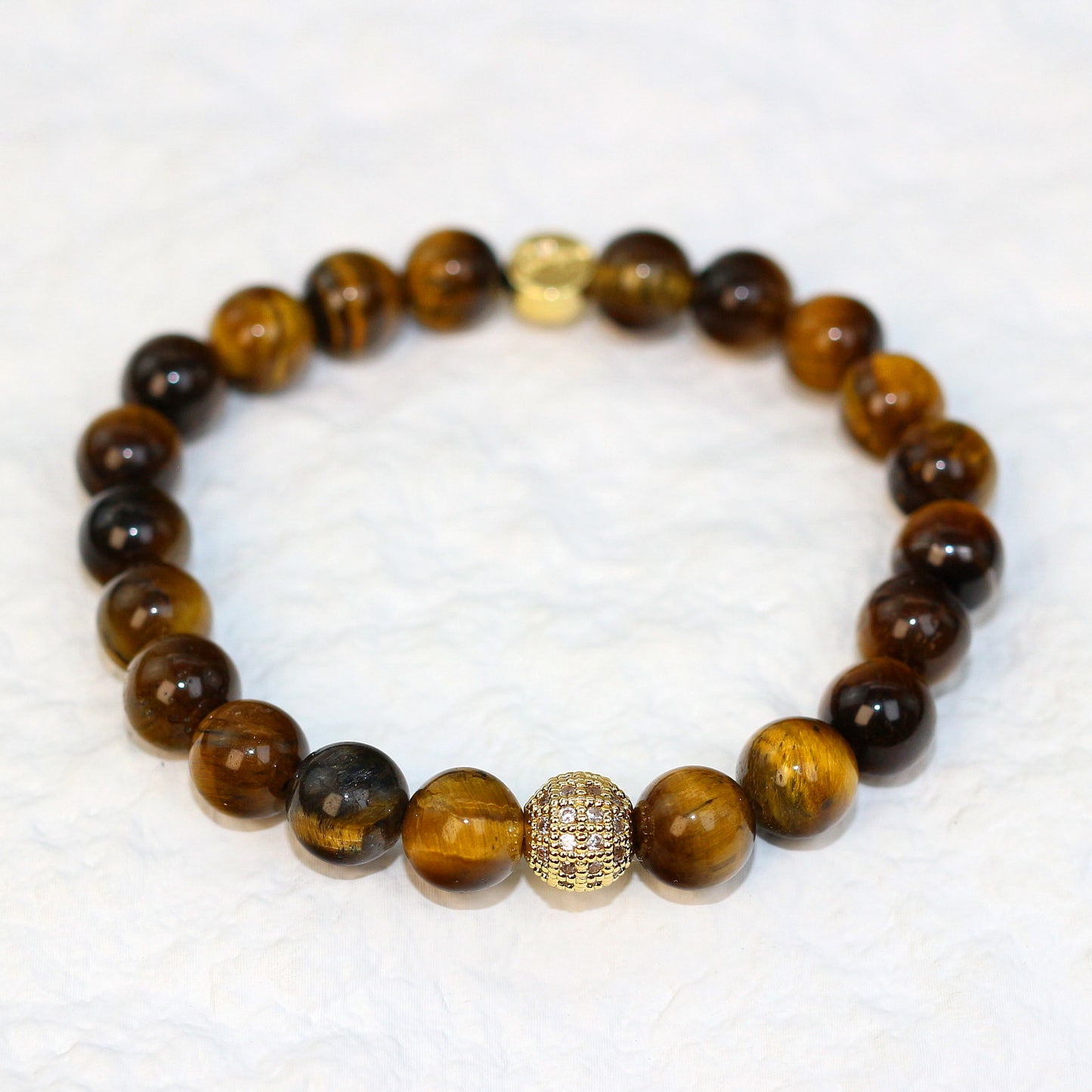 Front-facing view of the Tiger’s Eye Bracelet highlighting polished 8mm beads with natural chatoyancy, symbolizing strength and focus.