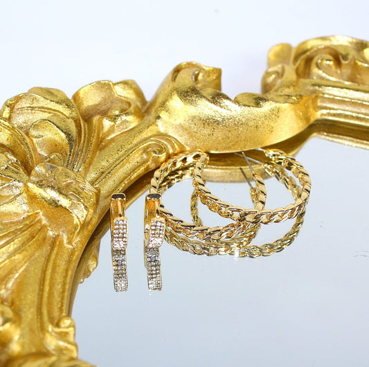 Urban Gleam Duo earrings by GinaKimKR – gold chain hoop and crystal CZ huggie displayed on reflective gold-framed mirror