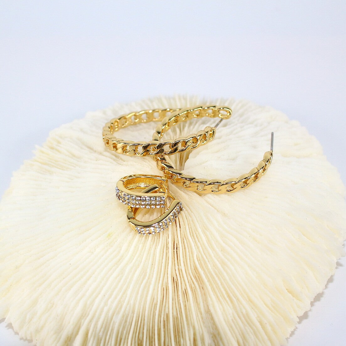 Layered composition of Urban Gleam Duo earrings – texture contrast between gold chain and pavé CZ