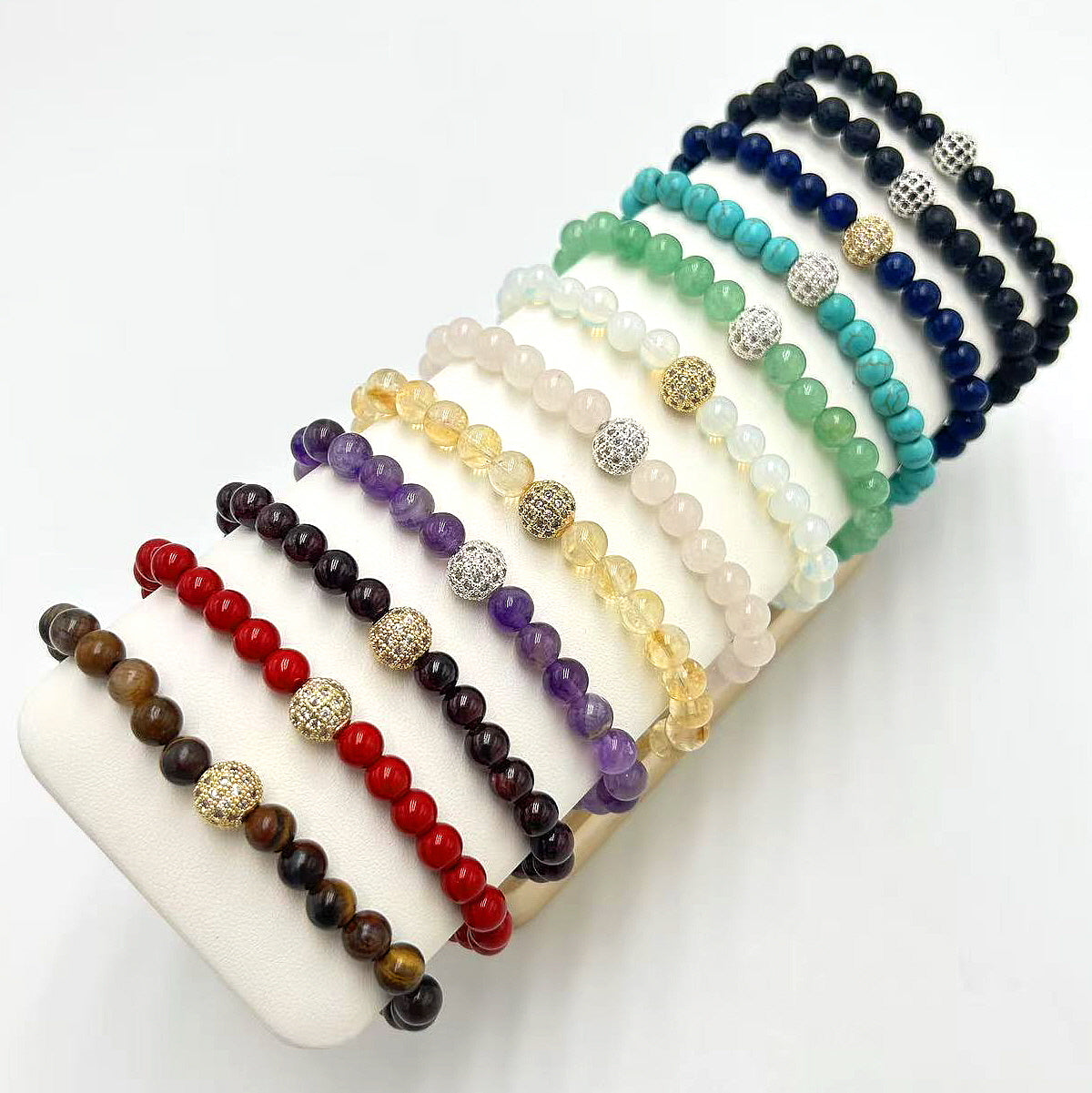 GinaKim Basic Fortune Bracelet collection featuring 12 natural stone colors: amethyst, rose quartz, moonstone, turquoise, citrine, lapis lazuli, garnet, peridot, tiger’s eye, crystal quartz, lava, and onyx