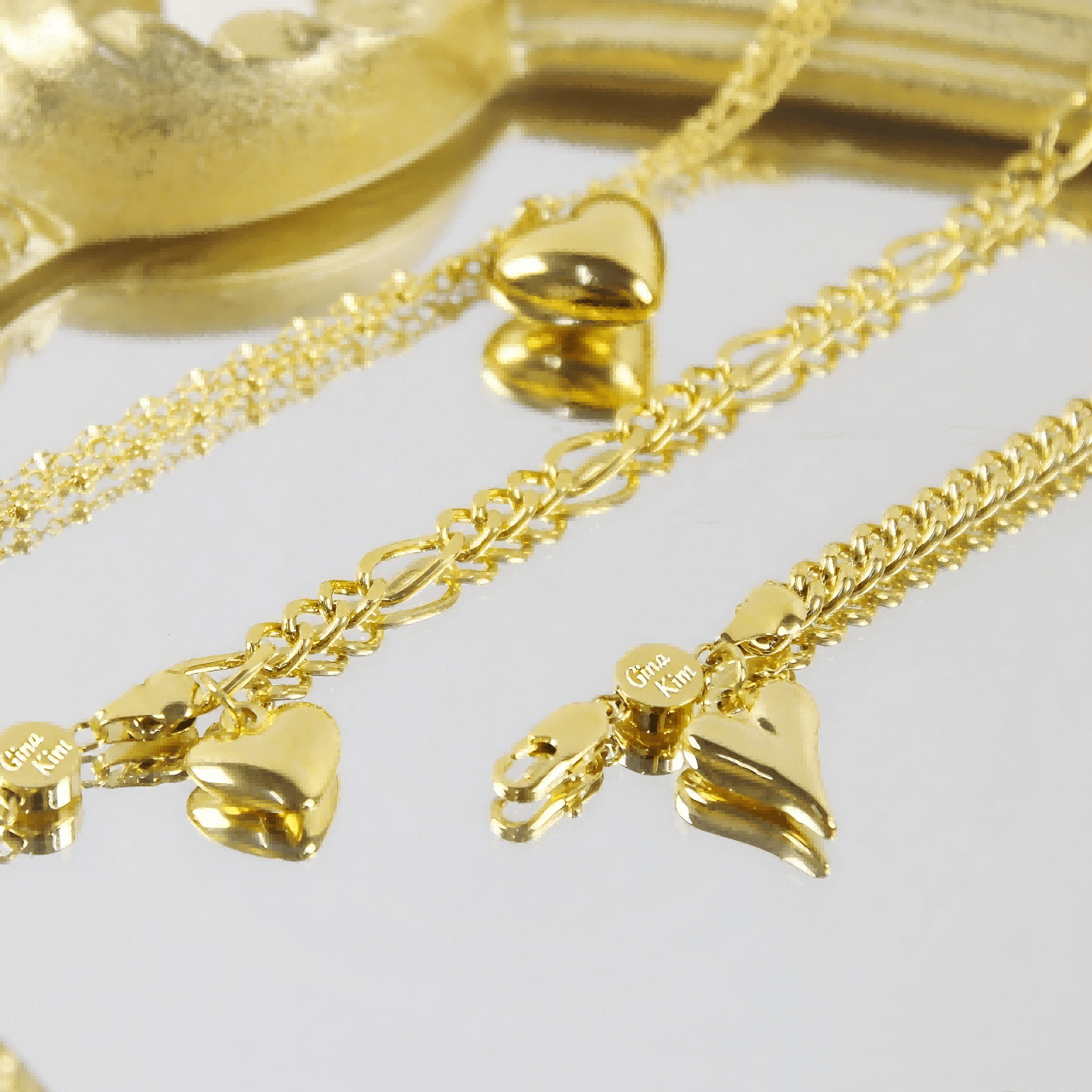 18kt Evergold Series | GinaKimKR featuring Figaro Heart Bracelet and matching gold chain heart jewelry.
