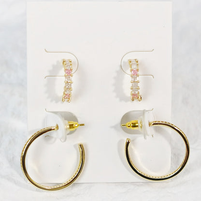 Full front shot of Blush Beam Earring Set, with geometric hoops and pearl-accented studs laid on neutral background.