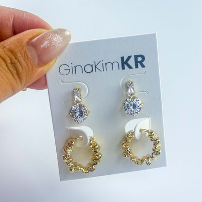 Handheld image of Gleam Ripple Earring Set on brand card, showcasing the scale and shine of this elegant accessory.