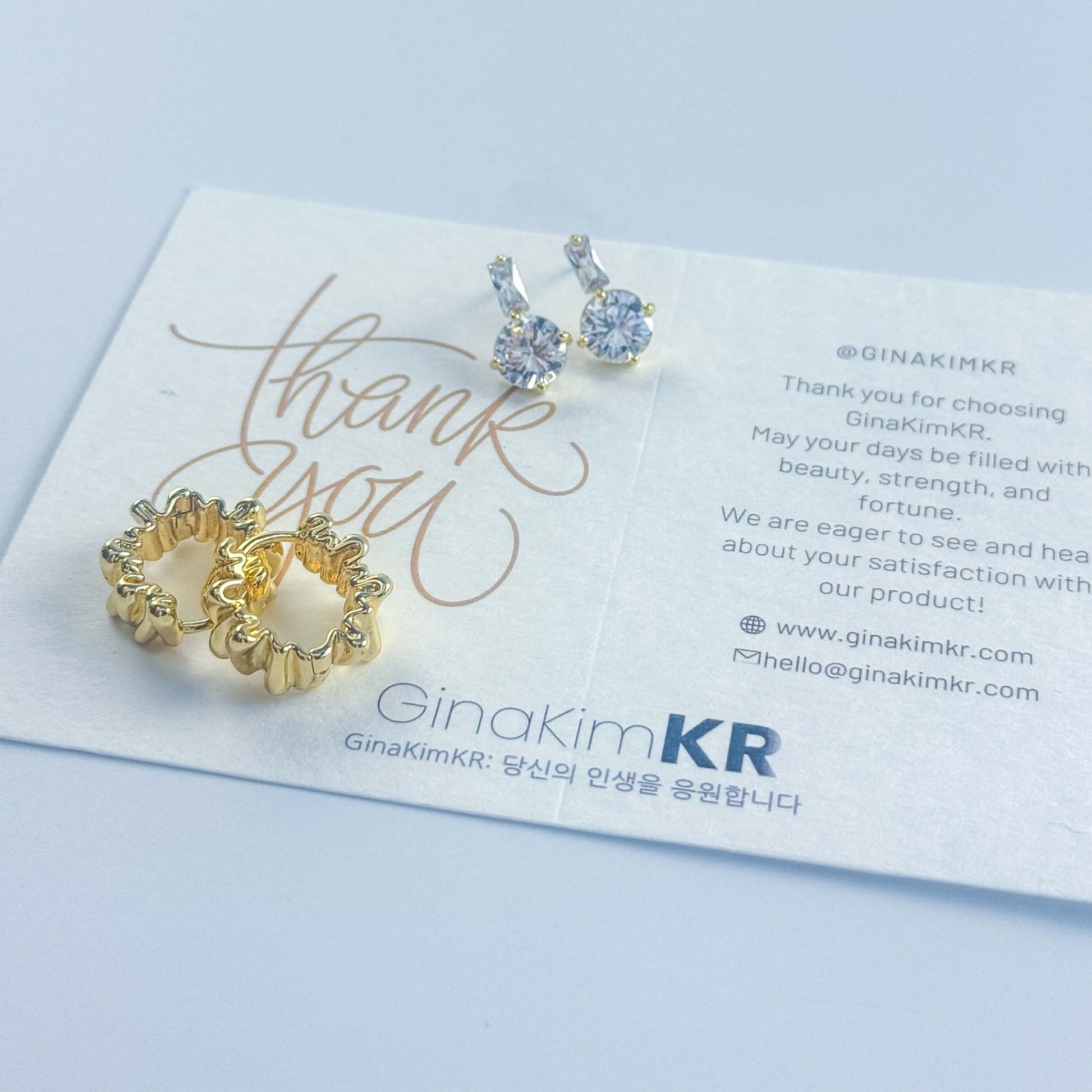 GinaKimKR’s Gleam Ripple Earring Set shown with brand care and message card, combining sparkle and thoughtful presentation.