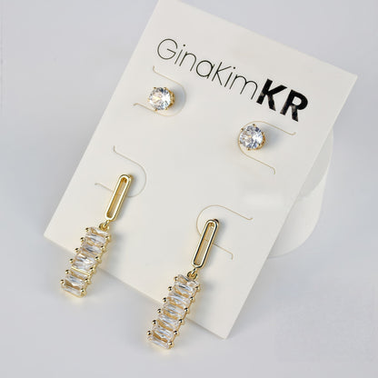 Minimal composition of GinaKimKR Lightfall Duo Earring Set, featuring sleek gold bar and stud drop designs.